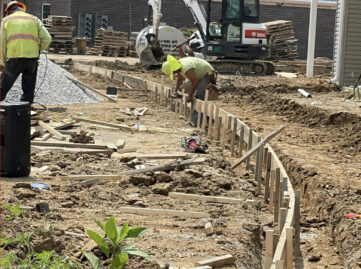 Preparing apartment site for curved concrete sidewalk